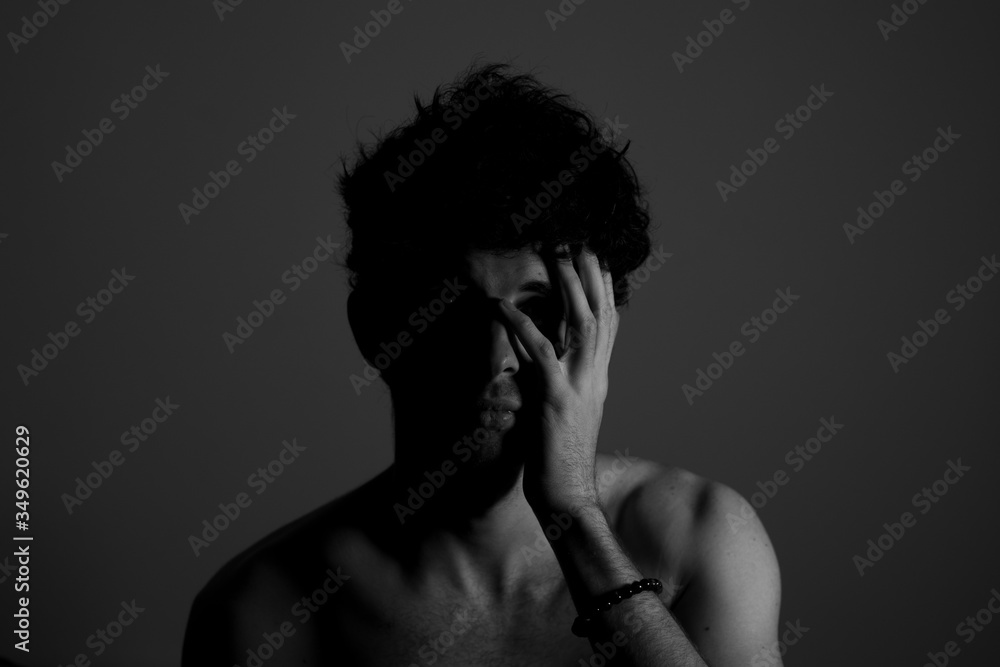Young man teenager touching head hand curly hear Young man teenager touching head hand curly hear