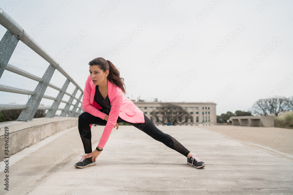 Athletic woman stretching legs before exercise. Athletic woman stretching legs before exercise.