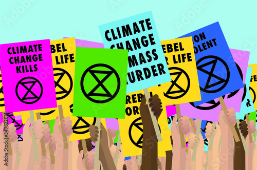 Hands holding Extinction Rebellion placards