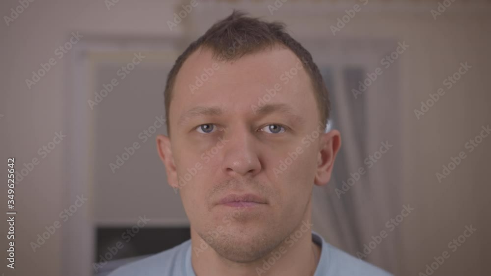 Portrait of a tired man stands against a window Portrait of a tired man stands against a window