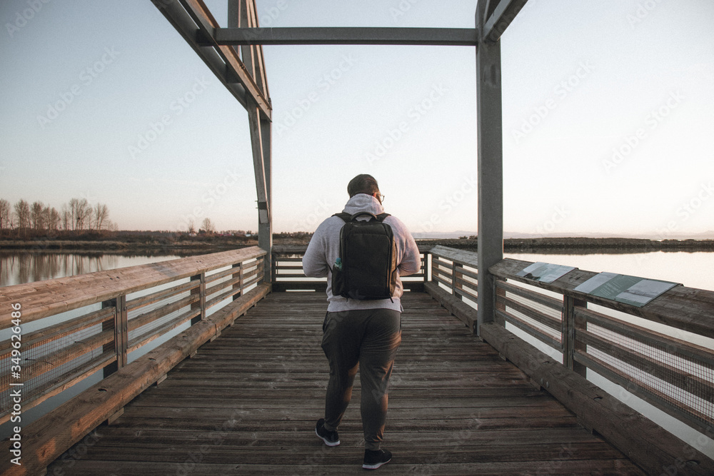 man walking in a pier