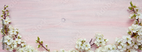 Spring flowering branch on wooden background. Copy space.