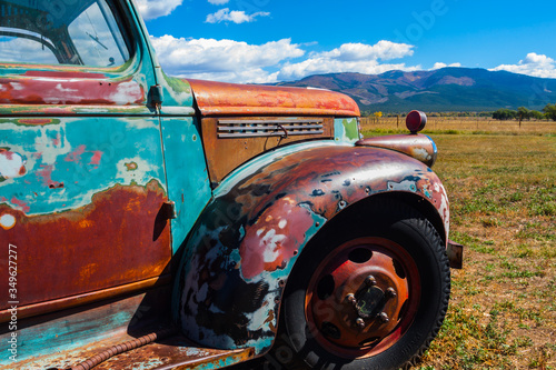 Old Multicolored Pickup  With Mountains, Taos, New Mexico, USA