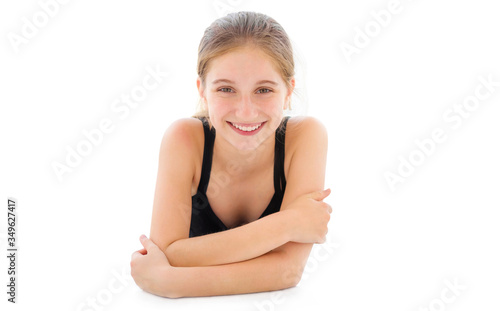 Cute teenager girl lying on a floor isolated on a white background