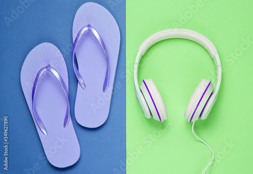 Flip flop and headphones on colored background. Summertime relax. Summer vacation. Beauty and fashion. Top view. Flat lay
