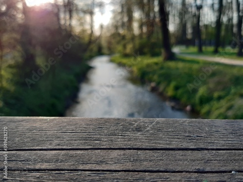 wooden handrail over the stream in the park