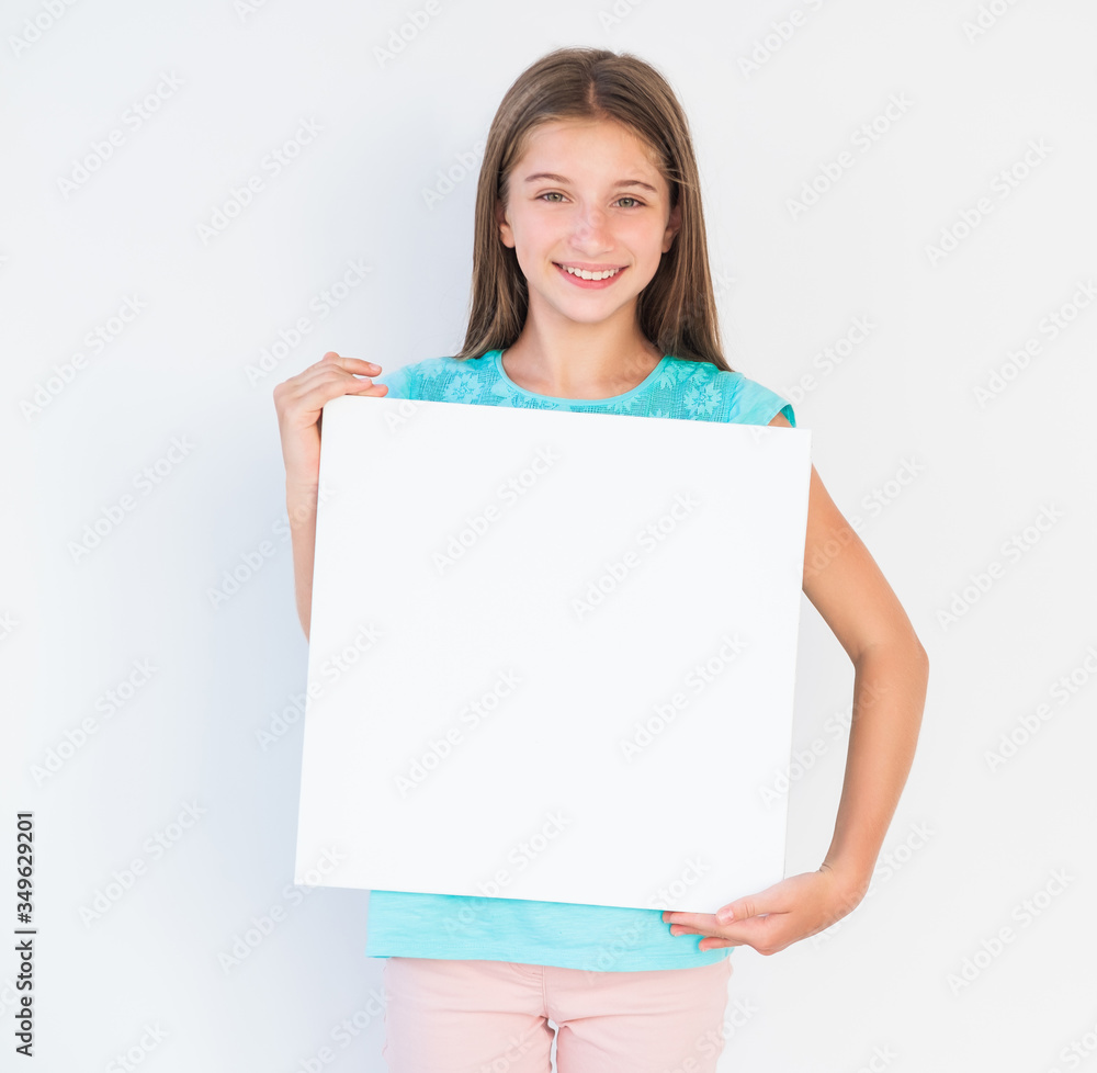 Adorable teen girl holding blank white canvas for copy space Adorable teen girl holding blank white canvas for copy space