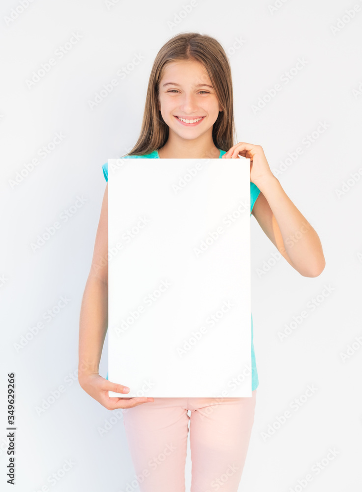 Portrait of a happy teenager girl with a blank canvas board Portrait of a happy teenager girl with a blank canvas board
