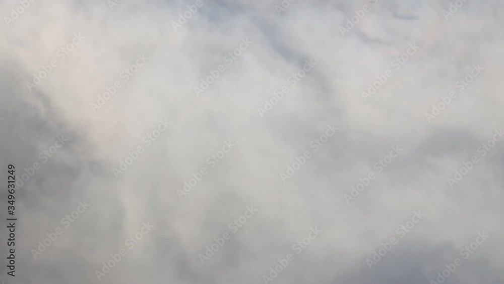 Flying in a plane through the fluffy, white clouds. Spectacular view from the window of an airplane Flying in a plane through the fluffy, white clouds. Spectacular view from the window of an airplane