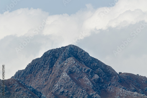 One Unique Hill Peak with blue sky and clouds in the background -nature concept. photo