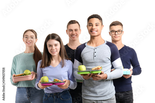 Pupils with tasty lunch on white background