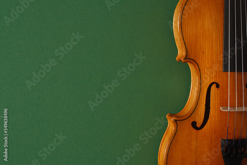 Classical music concert poster with brown color violin on dark green background with copy space for your text
