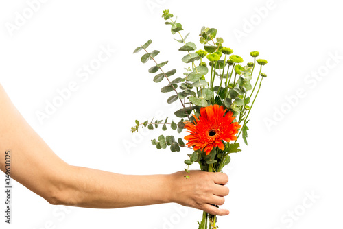 Woman hand holding a bouquet of flowers isolated on a white background. Mothers Day Concept.