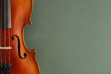 Classical music concert poster with brown color violin on dark green background with copy space for your text
