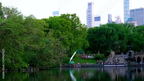 People hangout and relax in city park with city skyline background.