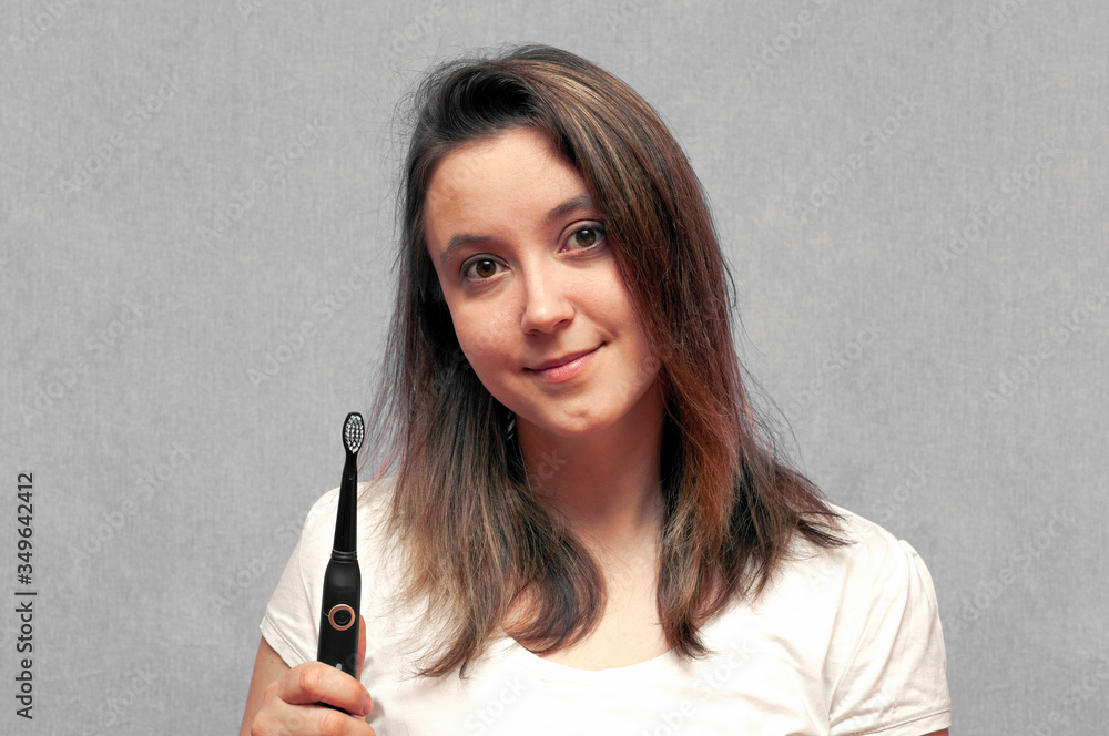 Pretty young girl with electric brush cleaning white teeth. Pretty young girl with electric brush cleaning white teeth.