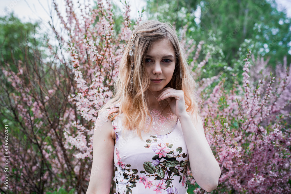 Girl in a delicate dress with mehendi on the body, in flowering almonds Girl in a delicate dress with mehendi on the body, in flowering almonds