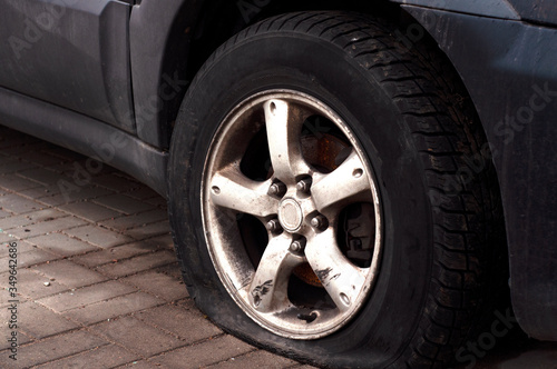 Car wheel flat tire on the road. Road accident