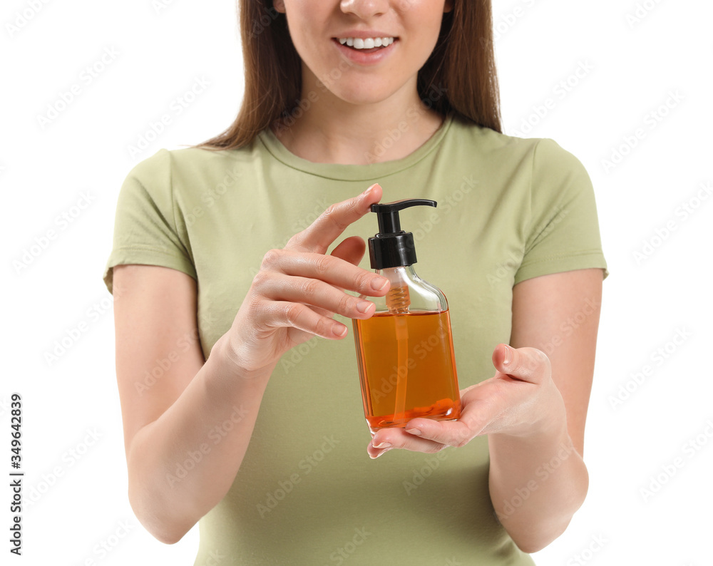 Young woman with cosmetics in bottle on white background Young woman with cosmetics in bottle on white background