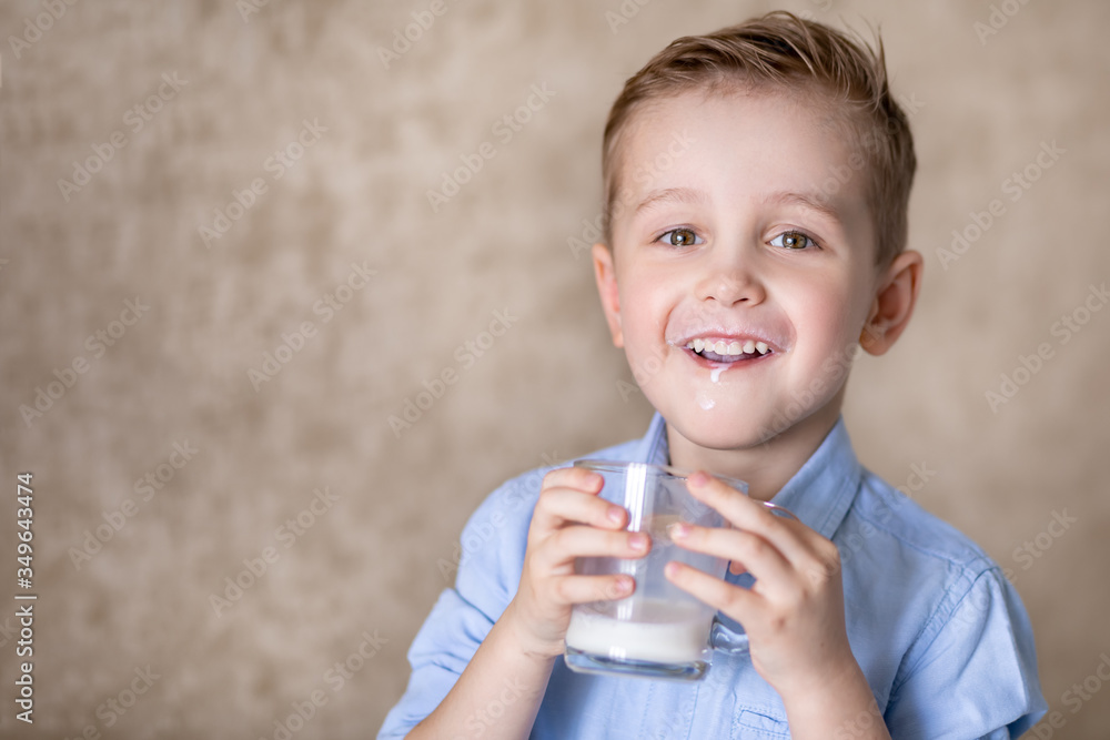 little boy enjoys drinking milk from a mug. little boy enjoys drinking milk from a mug.