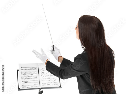 Young female conductor on white background photo