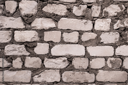 white brick wall with cement. rough masonry