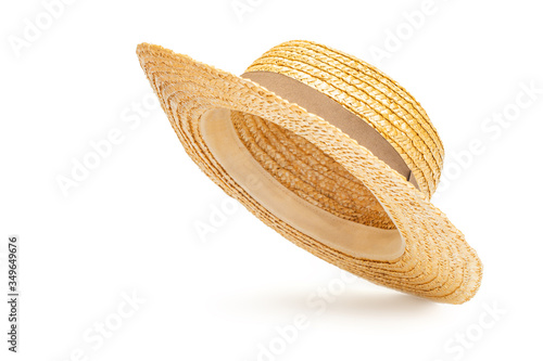 Boater straw hat flying isolated in studio. Concept of fashion clothing accessories and beach holidays photo