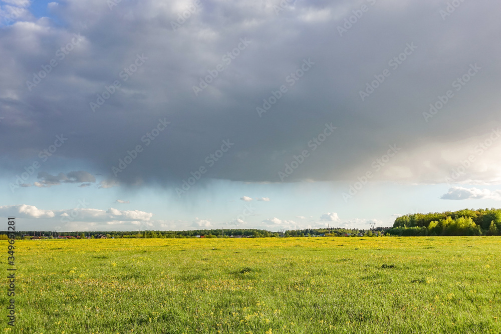 Country landscape. Green field and rain cloud Country landscape. Green field and rain cloud