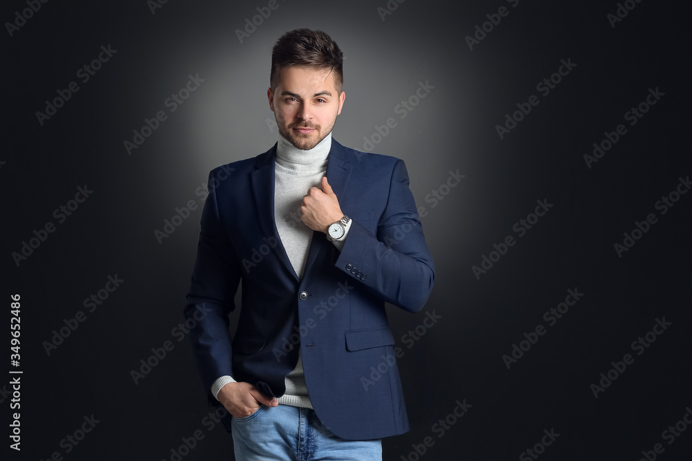 Handsome businessman with stylish hairdo on dark background Handsome businessman with stylish hairdo on dark background