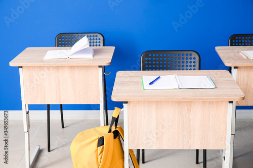 Modern school desks near co...