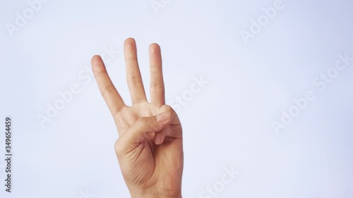 closeup male hand isolated on a white background three fingers raised up