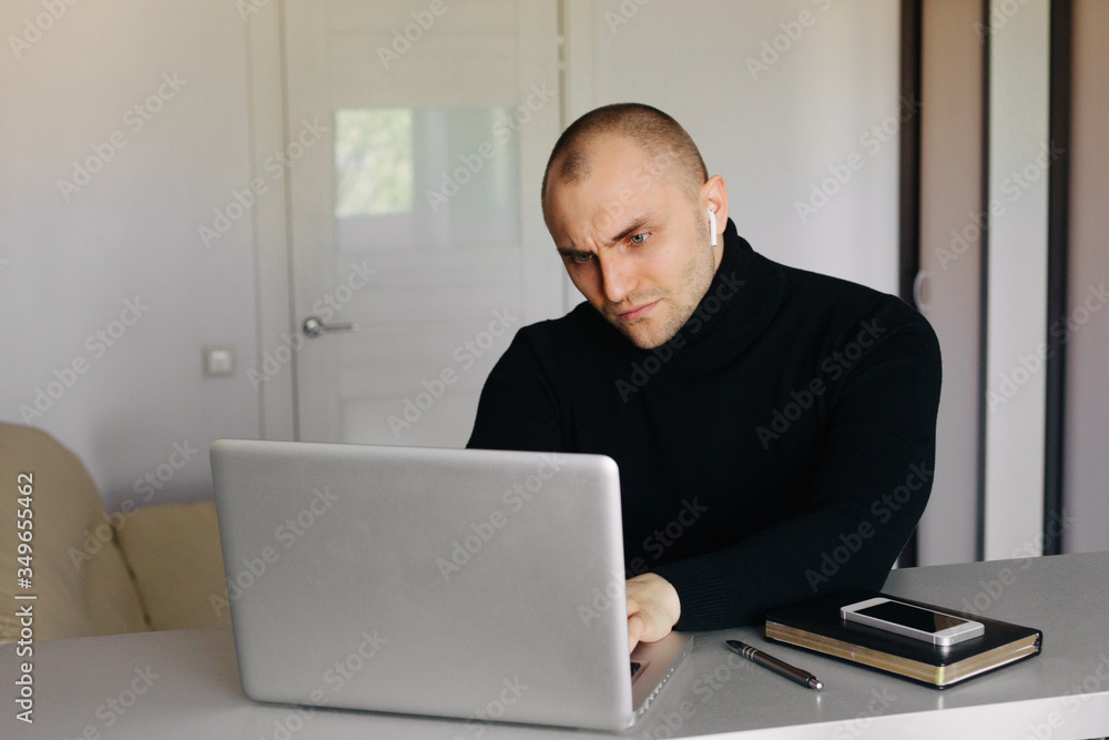 Pensive short haired man sitting at tablework at laptop thinking of problem solution, thoughtful male employee pondering considering idea looking at computer screen making decision Pensive short haired man sitting at tablework at laptop thinking of problem solution, thoughtful male employee pondering considering idea looking at computer screen making decision