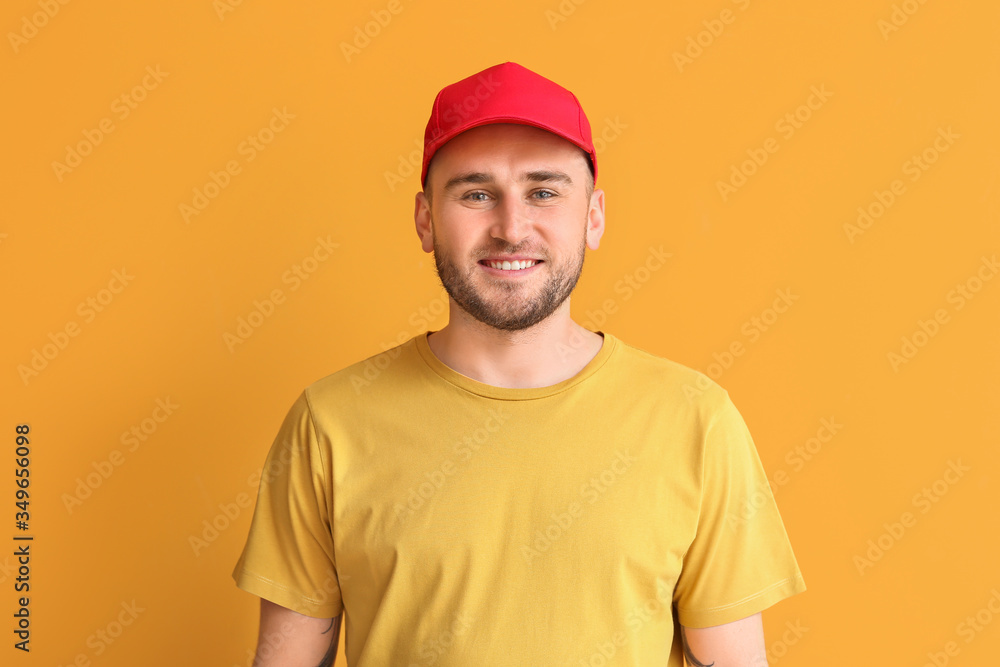 Handsome man in stylish cap on color background Handsome man in stylish cap on color background