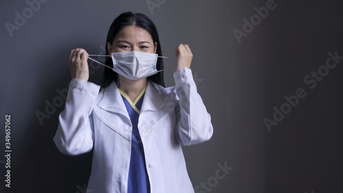 Fotografija Happy doctor takes off mask