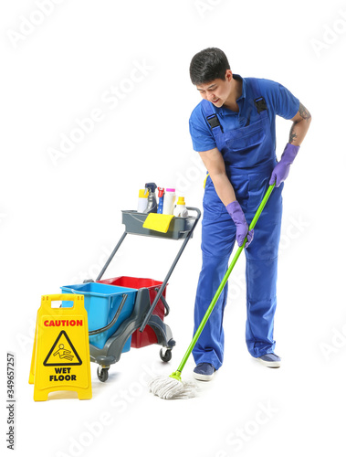 Male janitor with cleaning ...