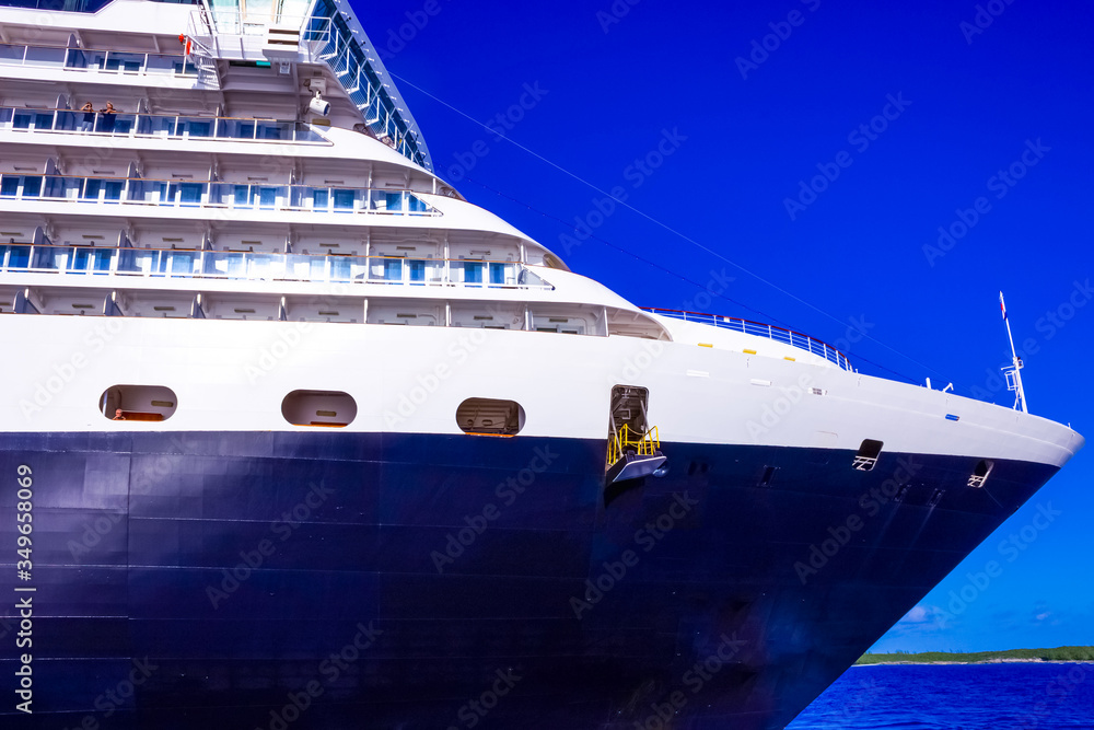 A view of a large cruise ship docked along the waterfront of Bahamas. A view of a large cruise ship docked along the waterfront of Bahamas.