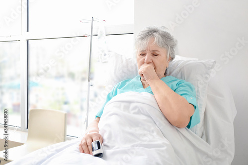 Coughing elderly woman in h...