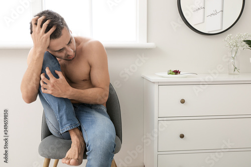 Sick man sitting near plate...