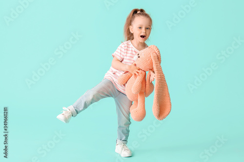 Little girl with toy on col...