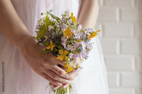 Bridesmaid with a bouquet of wildflowers photo