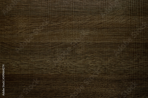 Laminated panel with dark wood texture, background.