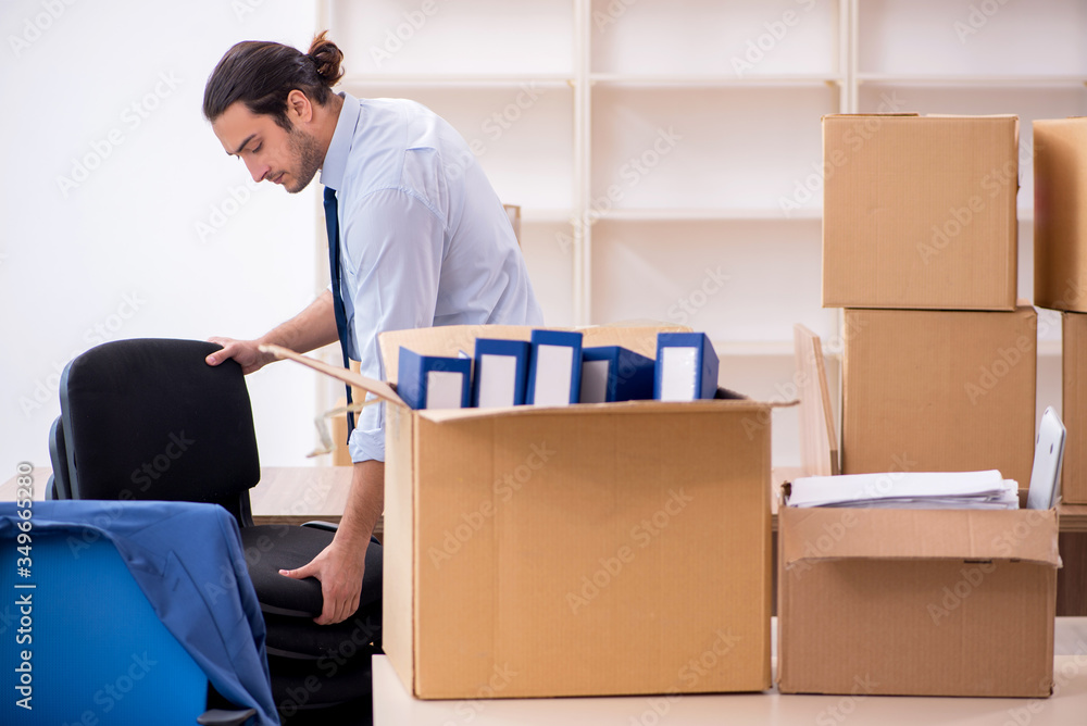 Young male employee in relocation concept Young male employee in relocation concept