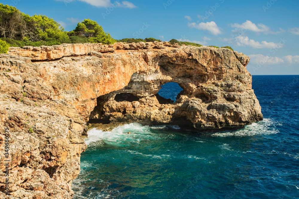 View on rocks with hole and deep blue sea.Mallorca Island, Spain