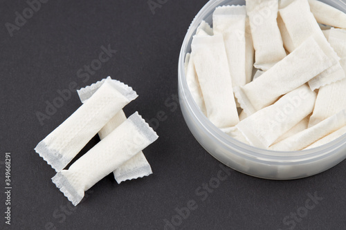 stack snus tobacco pouches over black background. copy space.