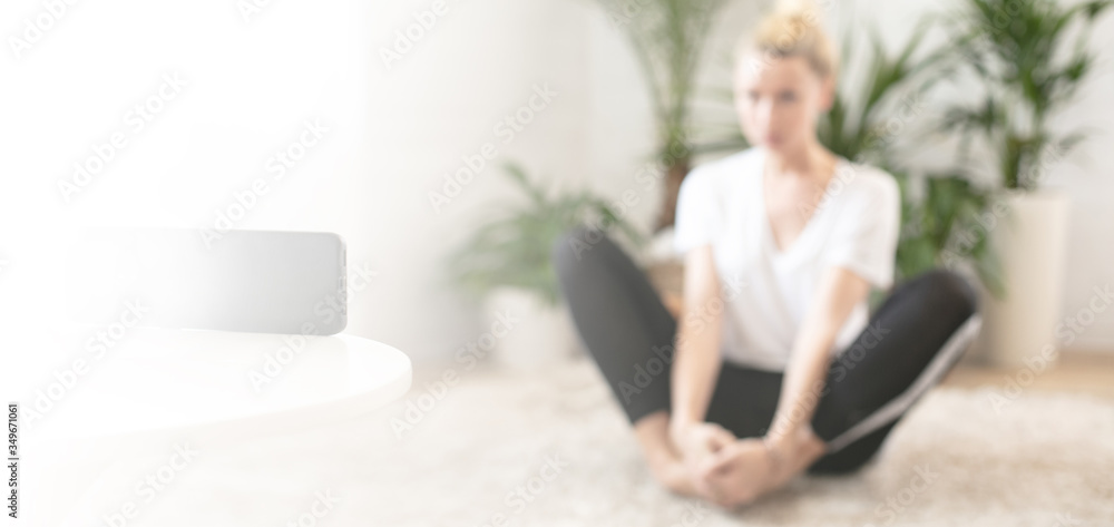 Healthy woman watching online yoga class on mobile phone. Healthy woman watching online yoga class on mobile phone.