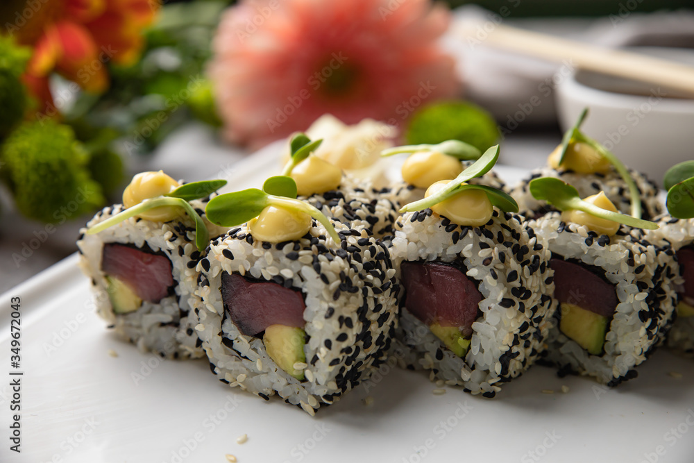 Japanese cuisine. Sushi roll with tuna on white background. Japanese cuisine. Sushi roll with tuna on white background.
