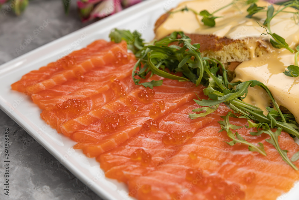 Breakfast - pancakes, cheese, caviar, salmon on a gray background Breakfast - pancakes, cheese, caviar, salmon on a gray background
