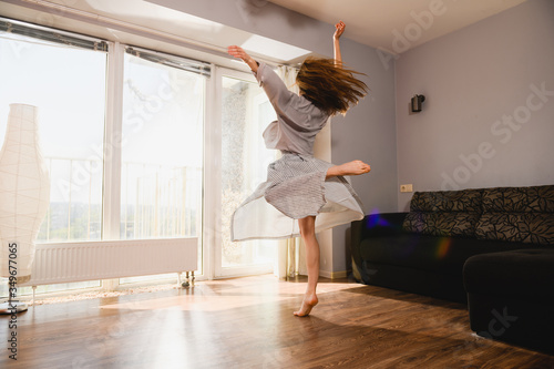 Woman dancing at home at isolation time photo