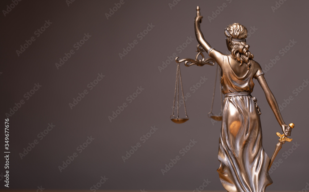 Statue of lady justice on bright background - Side view with copy space..