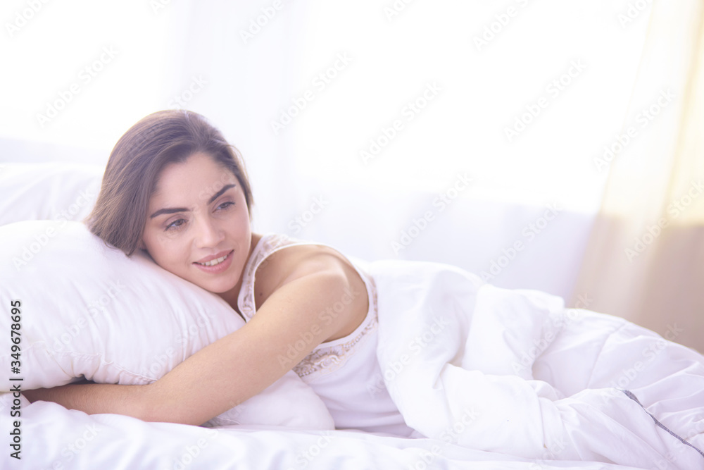 beautiful young woman basking in bed in the morning. Beautiful Model face looks sexy in camera beautiful young woman basking in bed in the morning. Beautiful Model face looks sexy in camera